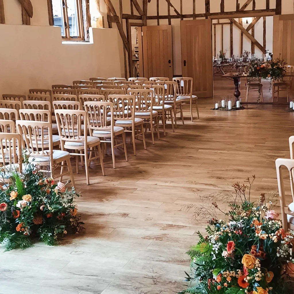 Wedding ceremony set up with Autumnal florals and candles at Bruisyard Hall wedding venue Norfolk 