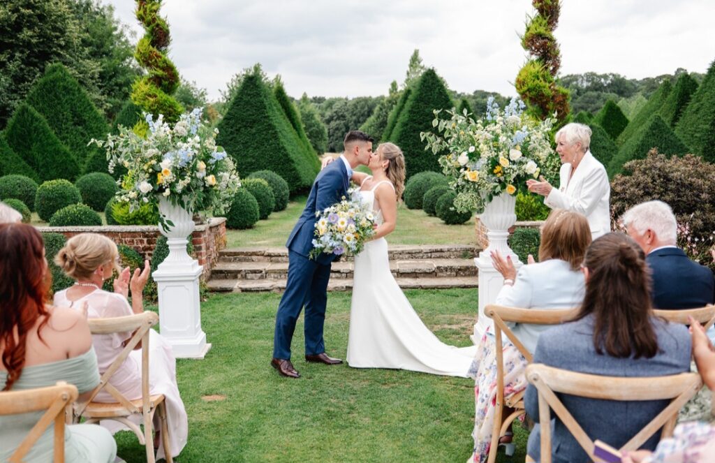 Emily and Patrick at Chaucer Barn Norfolk wedding venue. Soft blue, lemon, cream and white Bridal bouquet and ceremony urn arrangements.