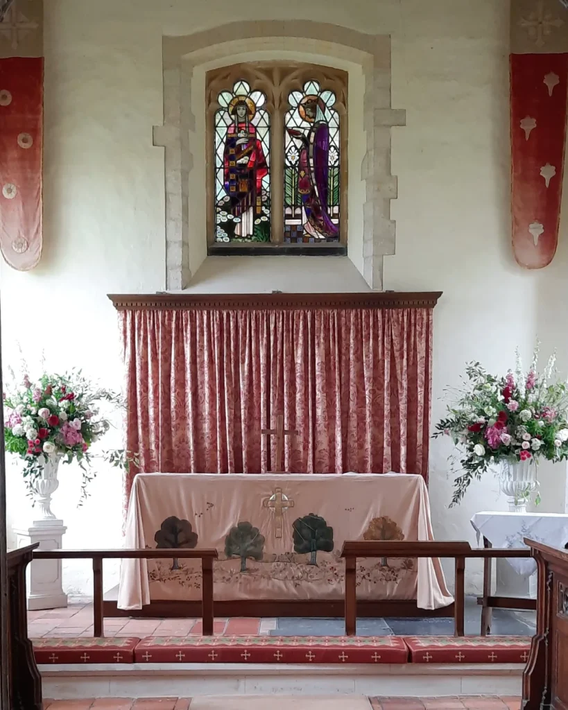 Floral urns at Burnham Market church in North Norfolk for a summer wedding