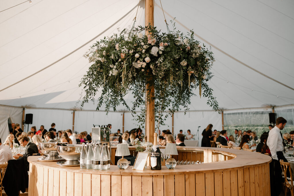 Marquee wedding at Low Barn Farm wedding venue Norfolk.  Featuring a statement hanging floral chandelier 