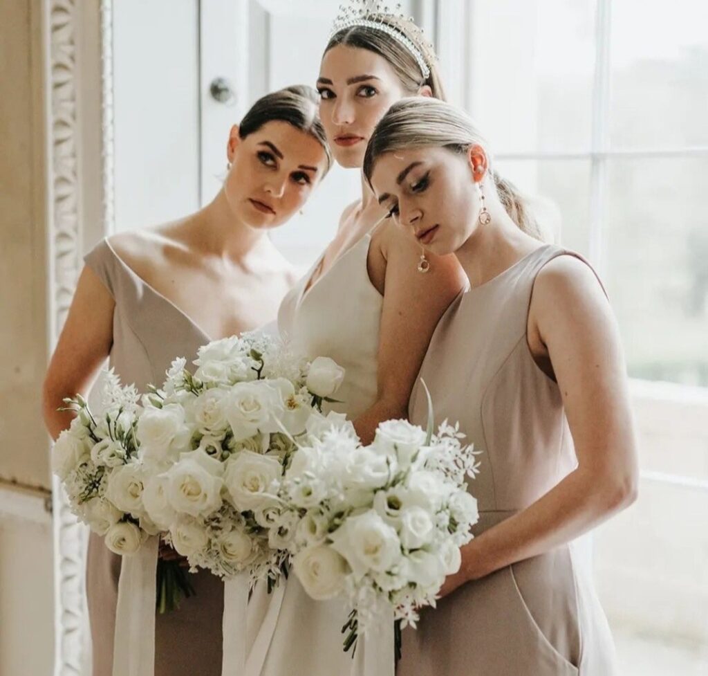 Elegant all white bridal bouquets with trailing delicate linen ribbon