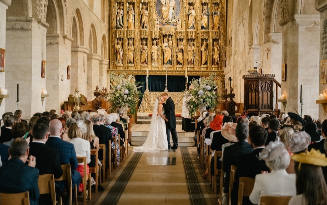 Wymondham Abbey wedding ceremony urns with pale blue and white flowers