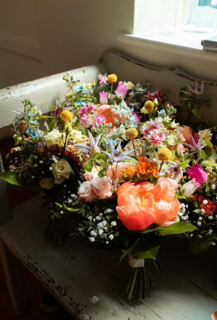Colourful meadow floral bridesmaids bouquets at The Woodyard Worstead Estate wedding venue in Norfolk 