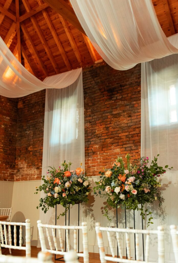 Colourful plinth wedding ceremony desigsn at The Woodyard Worstead Estate 