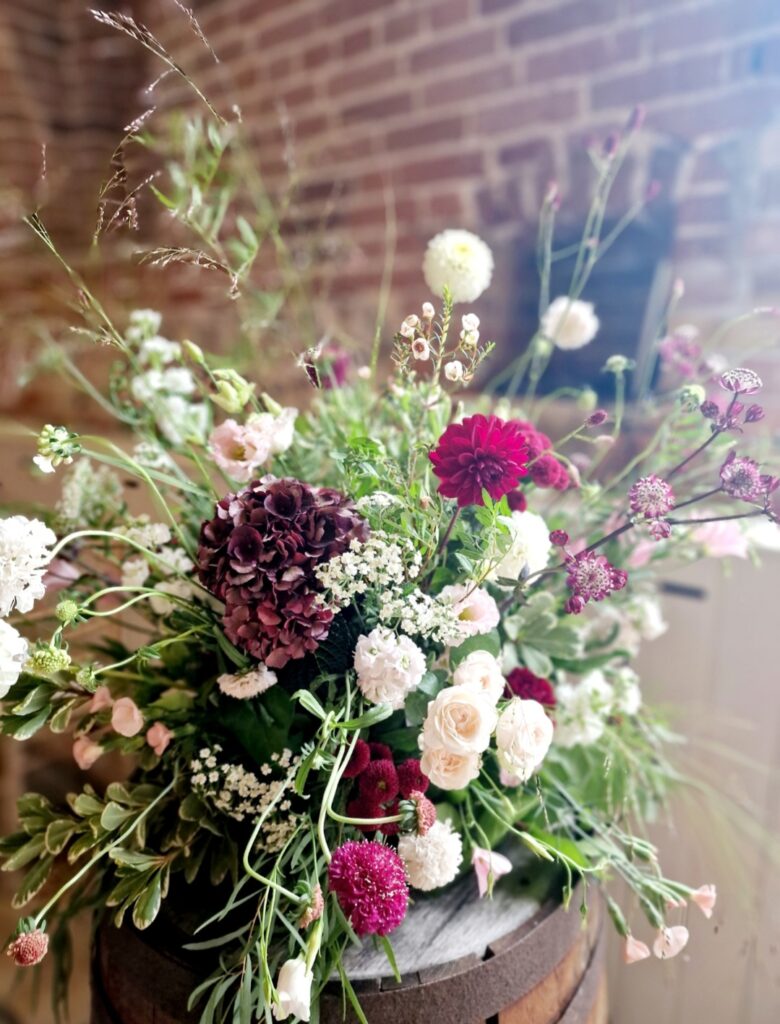 Burgundy, blush and white aisle ceremony arrangement at Manor Mews wedding venue in Norfolk 