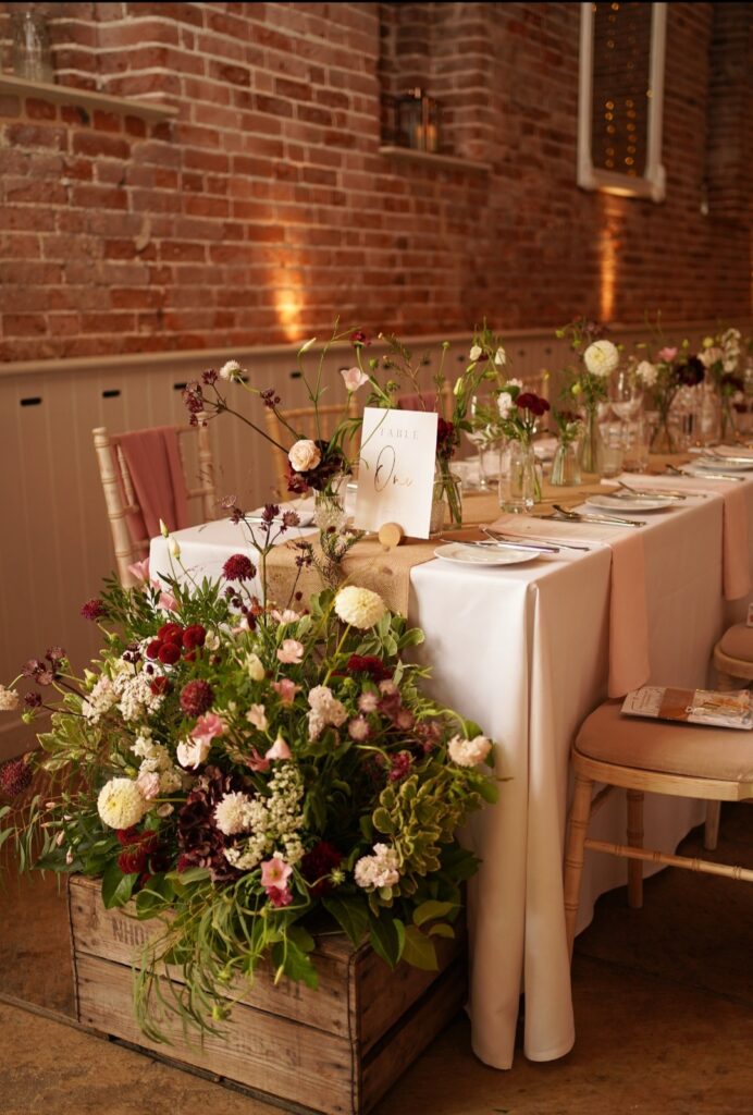Long table flowers at Manor Mews wedding venue