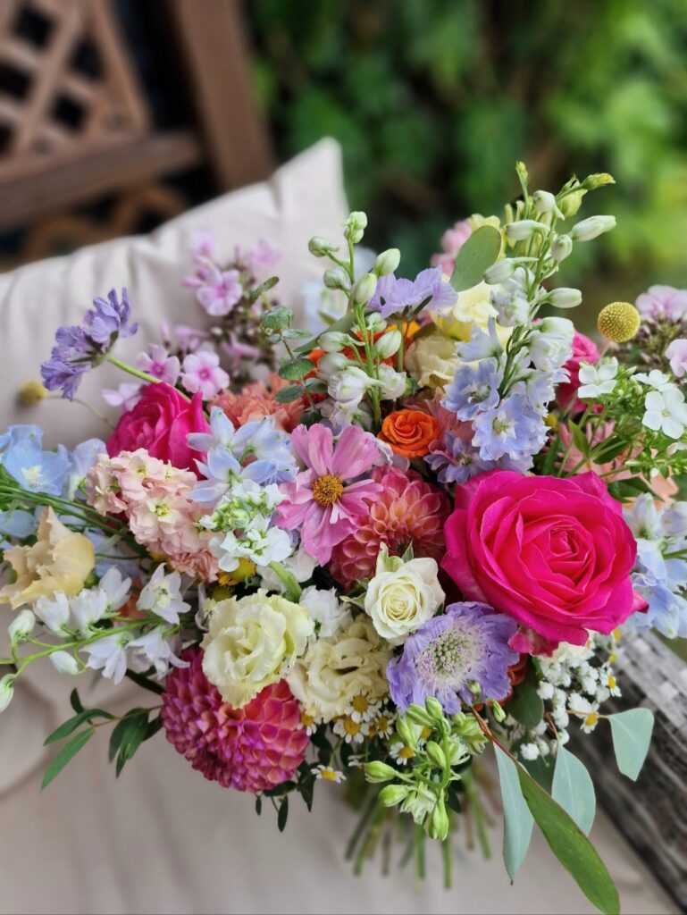 Natural garden bridal bouquet with flowers in mixed colourful shades at Chaucer Barn for Ellie